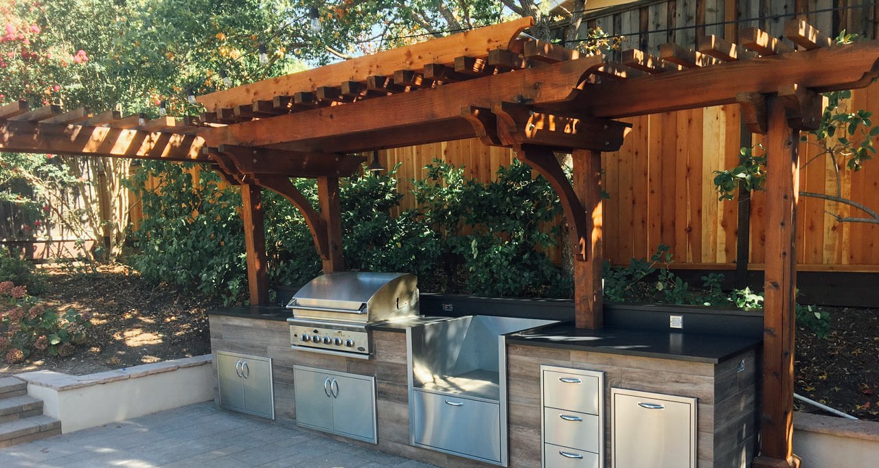 a small outdoor kitchenn pergola shading a kitchen setup
